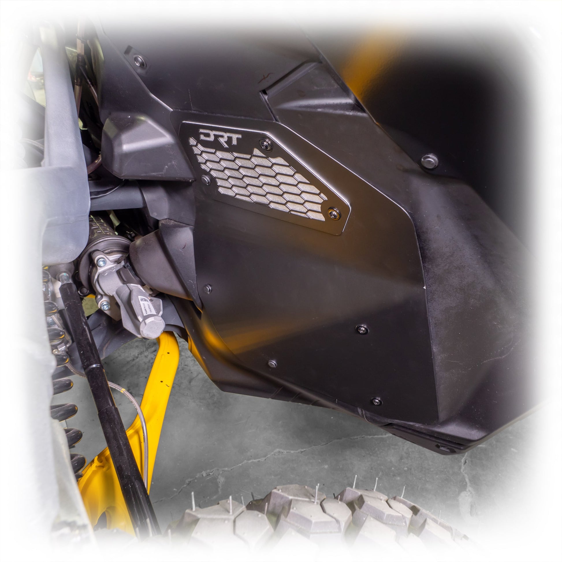Close-up of a front aluminum rock guard installed on a Maverick R.