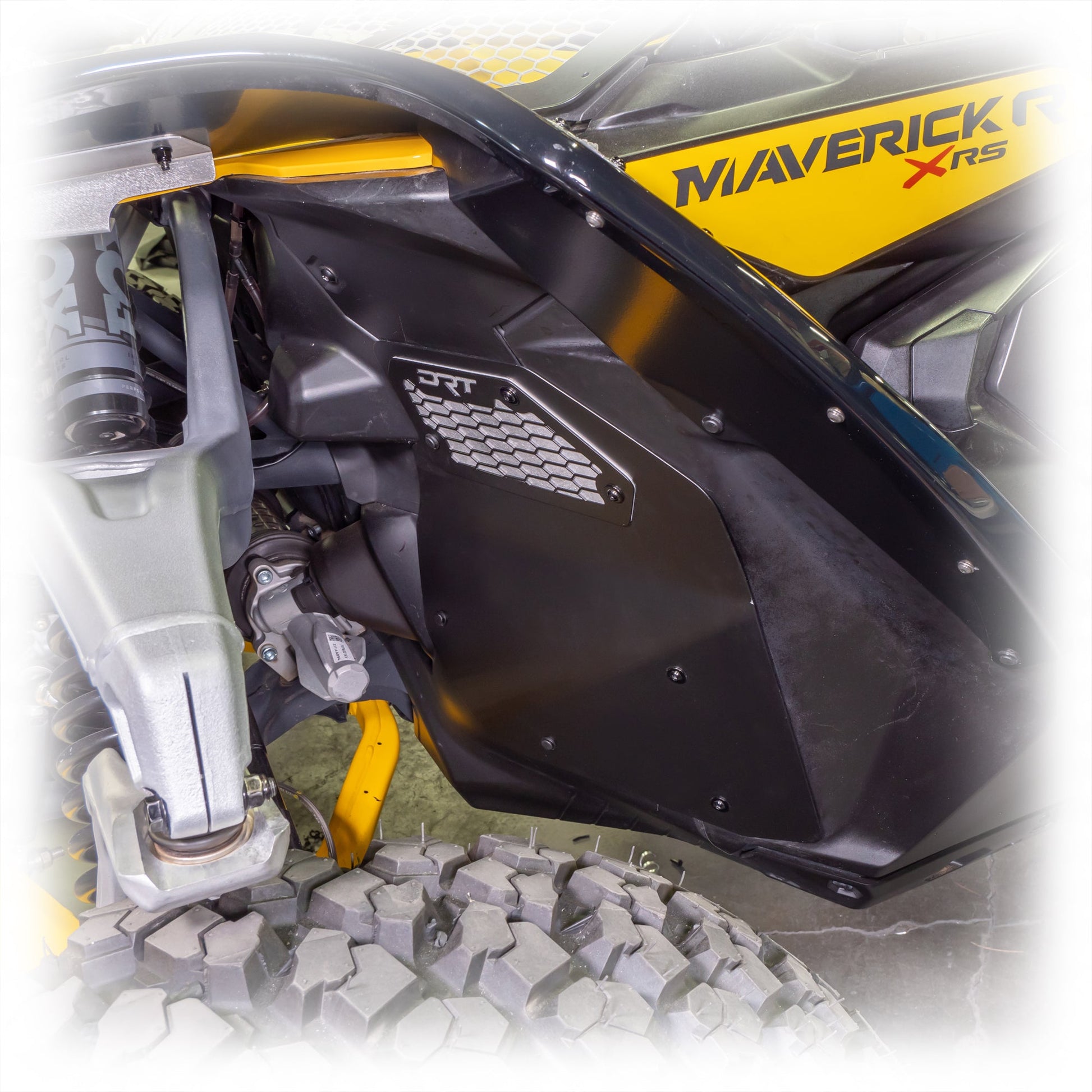Close-up of a front aluminum rock guard installed on a Maverick R.