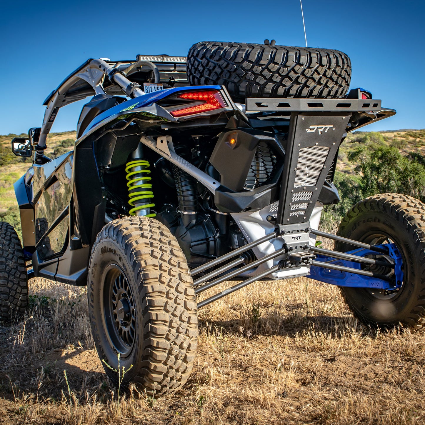DRT Can Am Maverick X3 2017+ Dual Sheer Radius Rod Plate Full rear view on a field